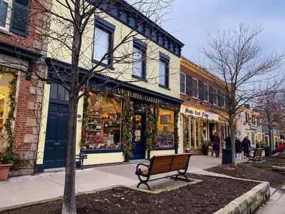 a bench on a city street with a store at Addison House License# 004-2025 in Niagara on the Lake