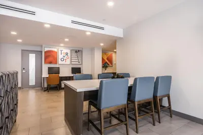 a waiting room with a table and chairs at Holiday Inn Express Toronto-North York by IHG in Toronto