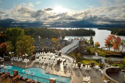 a view of a resort with a pool and a lake at JW Marriott The Rosseau Muskoka Resort & Spa in Minett
