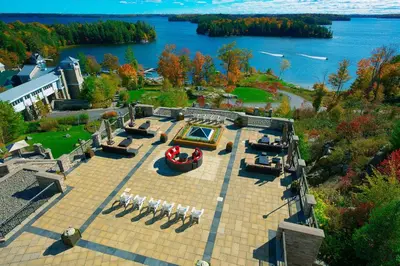 an aerial view of a patio with chairs and a lake at JW Marriott The Rosseau Muskoka Resort & Spa in Minett