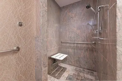 a bathroom with a shower with a toilet in it at JW Marriott The Rosseau Muskoka Resort & Spa in Minett