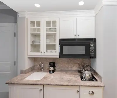 a kitchen with a sink and a microwave at JW Marriott The Rosseau Muskoka Resort & Spa in Minett