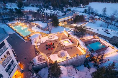 an aerial view of a house with a pool in the snow at JW Marriott The Rosseau Muskoka Resort & Spa in Minett