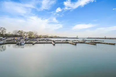 a large body of water with a pier and boats at The Jordan Hotel Ramada by Wyndham in Jordan