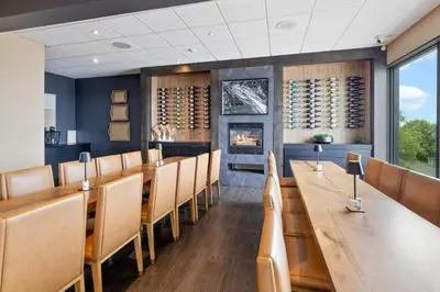 a dining room with a long table and chairs at The Jordan Hotel Ramada by Wyndham in Jordan