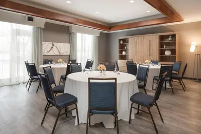 a conference room with tables and chairs in a room at Courtyard by Marriott Toronto Vaughan in Vaughan