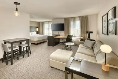 a hotel room with a couch and a bed at Residence Inn by Marriott Whitby in Whitby