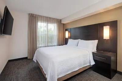 a hotel room with a large bed and a window at Residence Inn by Marriott Whitby in Whitby