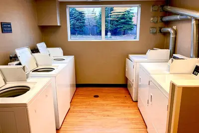 a laundry room with white counters and a window at Residence Inn by Marriott Whitby in Whitby