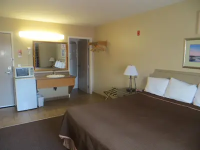 a hotel room with a bed and a bathroom at London Travel Inn in London
