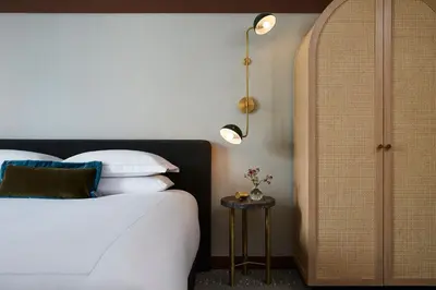 a bedroom with a bed and a side table at Kimpton Saint George Hotel by IHG in Toronto