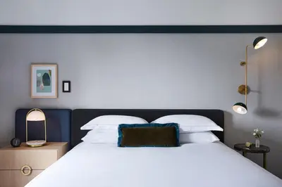 a bedroom with a large bed with white pillows at Kimpton Saint George Hotel by IHG in Toronto