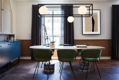 a kitchen with a table and green chairs at Kimpton Saint George Hotel by IHG in Toronto