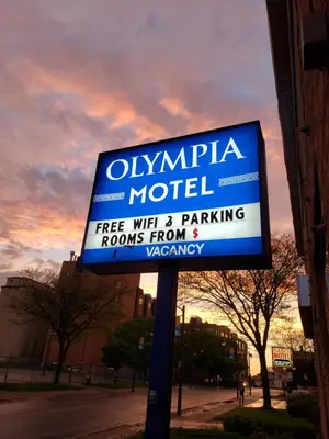 a sign for an olympia motel on a street at Olympia Motel in Niagara Falls
