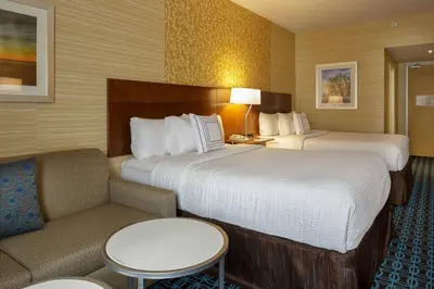 a hotel room with two beds and a couch at Fairfield Inn & Suites by Marriott Belleville in Belleville