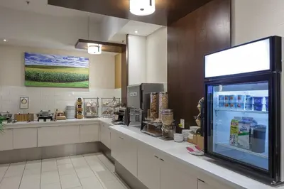 a coffee shop with a counter with a display case at Fairfield Inn & Suites by Marriott Belleville in Belleville