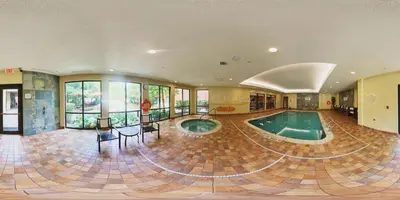 a large room with a swimming pool in a house at Courtyard by Marriott Hamilton in Hamilton