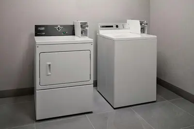 two white appliances sitting next to each other in a room at Courtyard by Marriott Hamilton in Hamilton