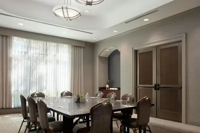 a dining room with a table and chairs at Courtyard by Marriott Hamilton in Hamilton