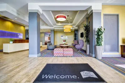 a lobby of a hotel with a welcome mat on the floor at Fairfield Inn & Suites by Marriott Guelph in Guelph
