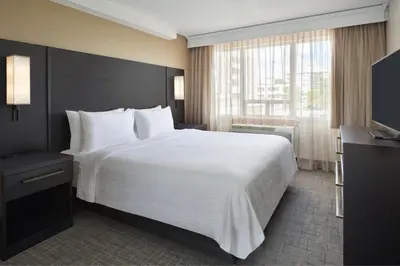 a hotel room with a large bed and a window at Residence Inn by Marriott London Canada in London