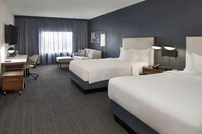 a hotel room with two beds and a desk at Courtyard by Marriott Toronto Markham in Markham