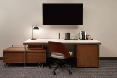 a desk with a chair and a monitor on a wall at Courtyard by Marriott Toronto Markham in Markham