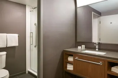 a bathroom with a sink and a mirror at Courtyard by Marriott Toronto Markham in Markham