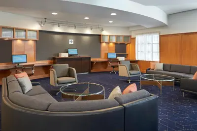 a large waiting room with couches and chairs and a board at Courtyard by Marriott Toronto Markham in Markham