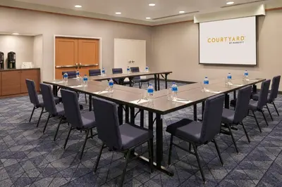a conference room with a long table and chairs at Courtyard by Marriott Toronto Markham in Markham