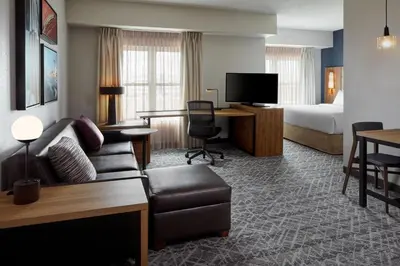 a hotel room with a couch and a bed at Residence Inn by Marriott Mississauga-Airport Corporate Centre West in Mississauga