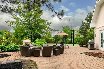 a patio with chairs and a table and an umbrella at Residence Inn by Marriott Toronto Markham in Markham
