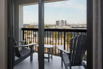 two chairs and a table on a balcony with a view at Courtyard by Marriott Mississauga-Airport Corporate Centre West in Mississauga