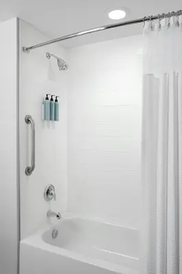 a bathroom with a shower with a white shower curtain at Courtyard by Marriott Mississauga-Airport Corporate Centre West in Mississauga
