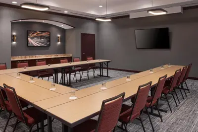 a conference room with a large table and chairs at Courtyard by Marriott Mississauga-Airport Corporate Centre West in Mississauga