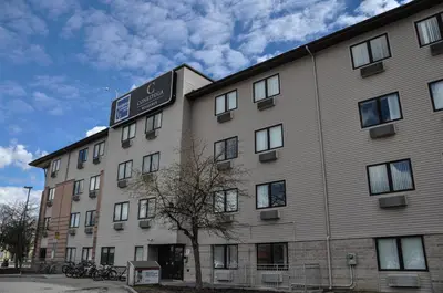 a building with a sign on the side of it at Residence & Conference Centre - Kitchener-Waterloo in Kitchener
