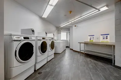 a laundry room with washing machines and a counter at Residence & Conference Centre - Toronto in Toronto