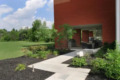 a brick building with a walkway in front of it at Residence & Conference Centre - Brampton in Brampton