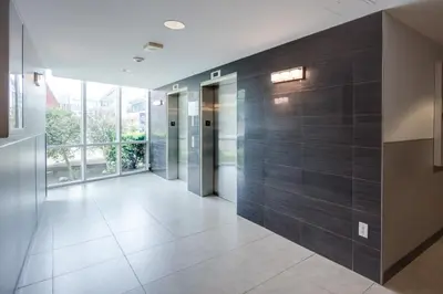 a hallway with wooden walls and a large window at Residence & Conference Centre - Brampton in Brampton