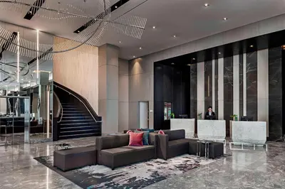 a lobby of a hotel with a couch and a staircase at Toronto Marriott Markham in Markham