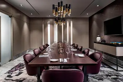 a conference room with a long table and purple chairs at Toronto Marriott Markham in Markham