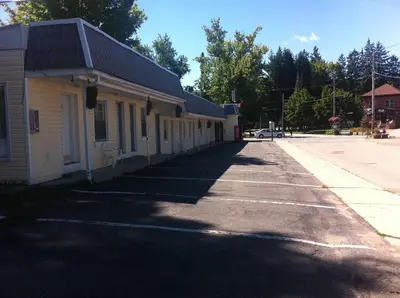 an empty street in front of a building at Bracebridge Inn in Bracebridge