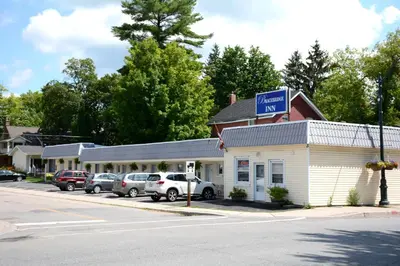 a mobil gas station with cars parked in a parking lot at Bracebridge Inn in Bracebridge