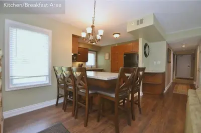 a kitchen and dining room with a table and chairs at Large modern ground floor condo at Mountain Walk in Blue Mountains