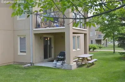 a picnic table in front of a building with a grill at Large modern ground floor condo at Mountain Walk in Blue Mountains