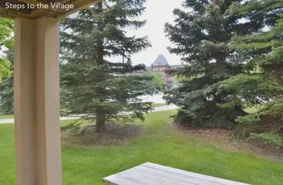 a view of a house from a porch with trees at Large modern ground floor condo at Mountain Walk in Blue Mountains