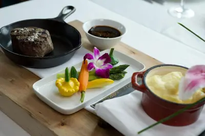 a table with a plate of food and a cup of coffee at The Waterside Inn in Mississauga