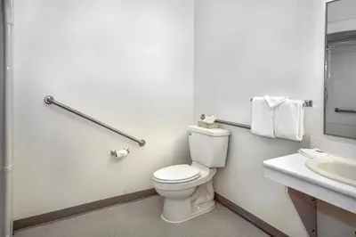 a white bathroom with a toilet and a sink at Motel 6-Peterborough, ON in Peterborough