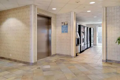 a hallway with a metal elevator in a building at Motel 6-Peterborough, ON in Peterborough