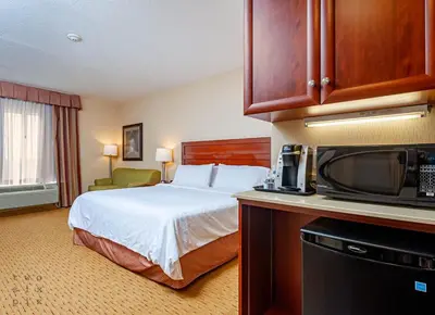 a hotel room with a bed and a microwave at Holiday Inn Express Hotel & Suites Clarington - Bowmanville by IHG in Bowmanville